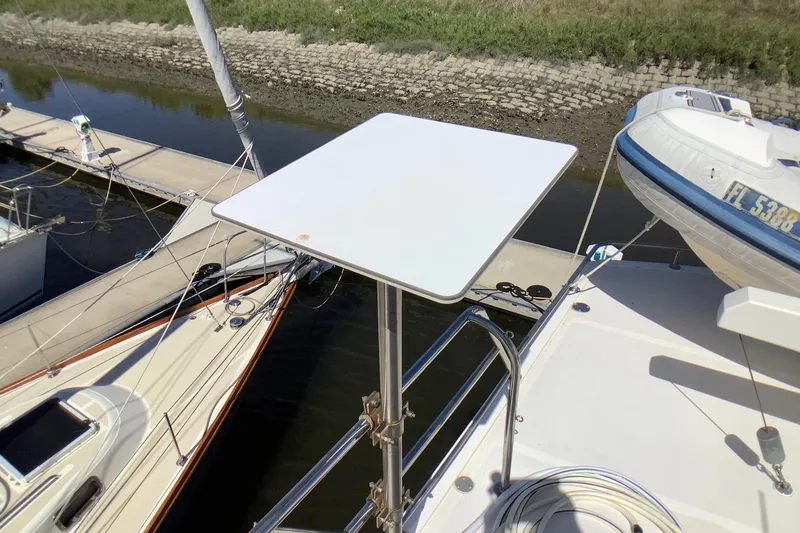 Slide: The Image of Grand Alaskan 60 Pilothouse 1998 yacht with a mounted table, docked alongside other boats. - 48