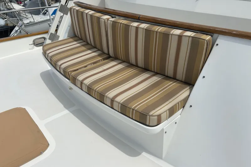 Slide: The Image of Striped cushioned seating on 1998 Grand Alaskan 60 Pilothouse yacht deck. - 8