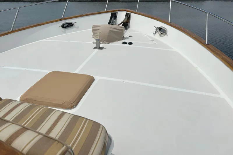 Slide: The Image of Bow deck of 1998 Grand Alaskan 60 Pilothouse with cushions and railing. - 9