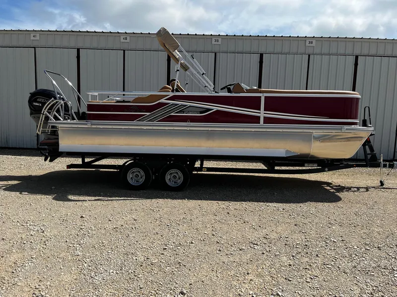 The Image of 2025 SunCatcher Fusion 324SS pontoon boat on trailer, parked outdoors. - 0