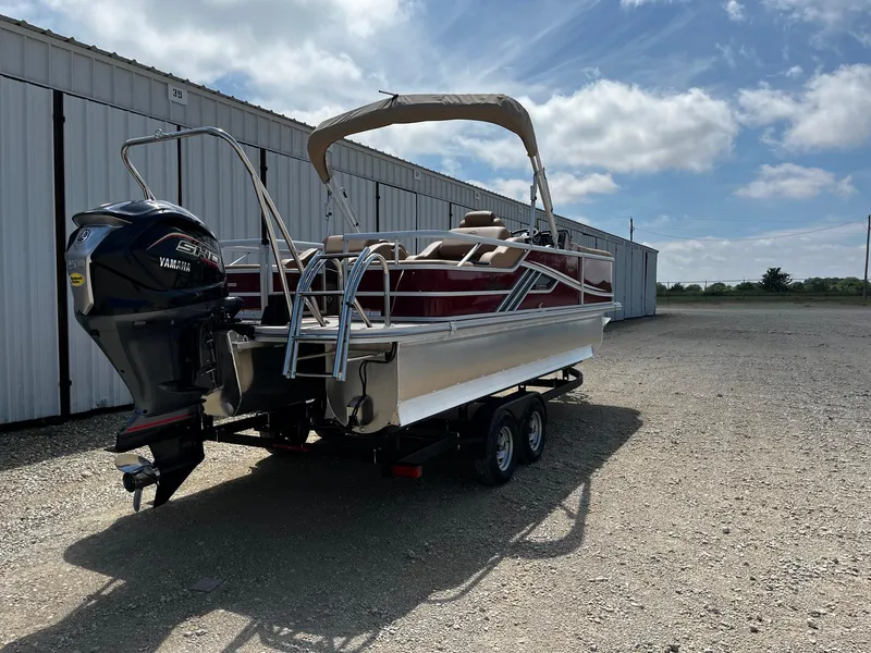 Slide: The Image of 2025 SunCatcher Fusion 324SS pontoon boat with Yamaha outboard motor on trailer. - 7