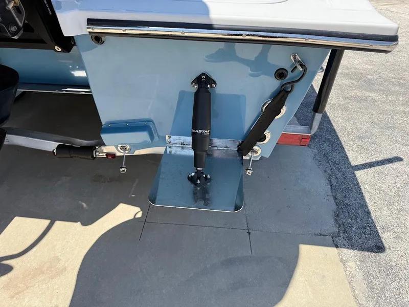 Slide: The Image of Rear view of 2025 Shallow Sport 24 Modified V boat with trim tab detail. - 13