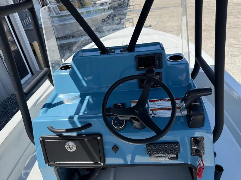 Slide: The Image of 2025 Shallow Sport 24 Modified V boat console with steering wheel and controls. - 16