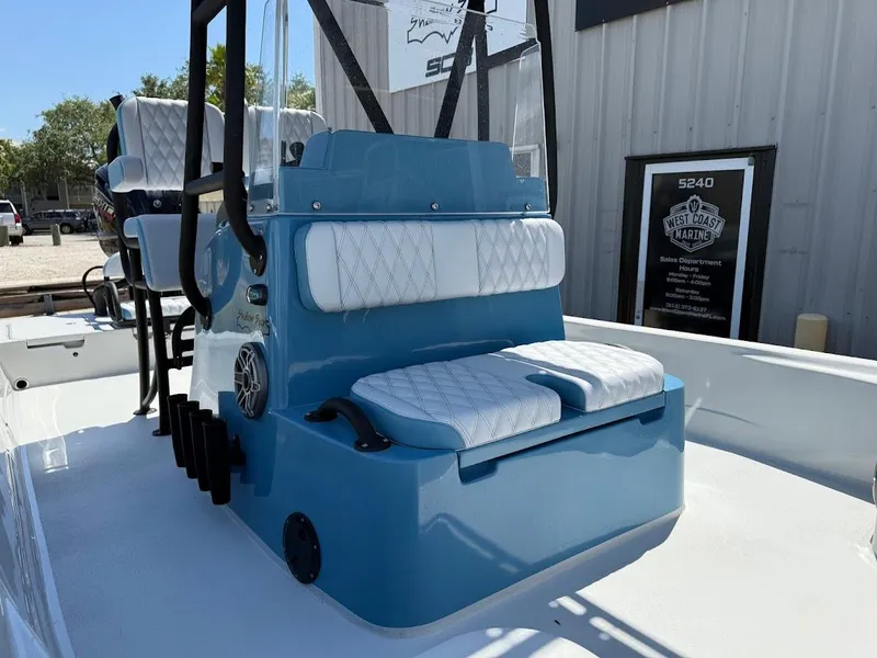 Slide: The Image of 2025 Shallow Sport 24 Modified V boat with blue seating and white cushions. - 4