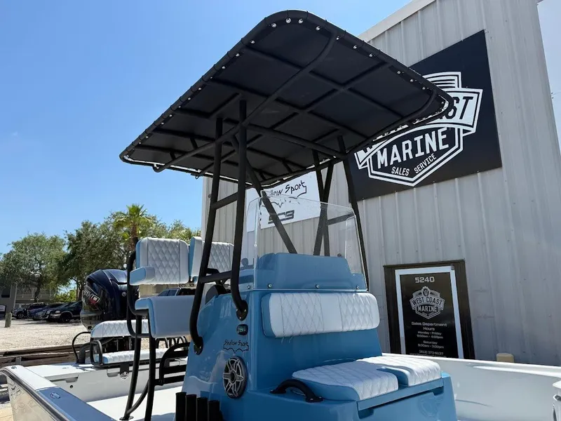 Slide: The Image of 2025 Shallow Sport 24 Modified V boat with T-top, parked at a marine sales center. - 5