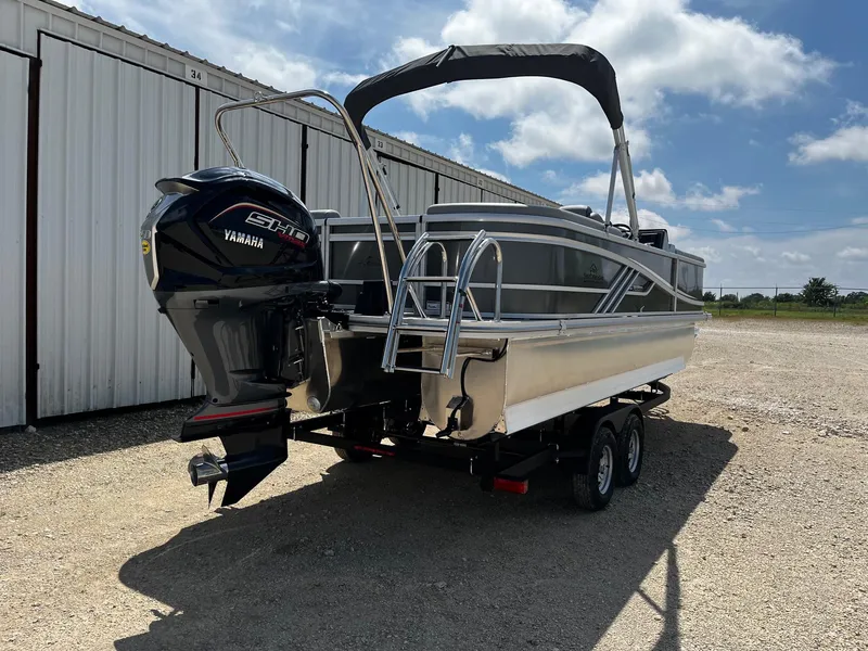 Slide: The Image of 2025 SunCatcher Fusion 324RC pontoon boat with Yamaha engine, parked outdoors. - 7