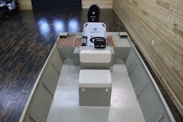 Slide: The Image of 2023 XTREME BOATS Brute 1754 CC interior with seating and console in a wooden showroom. - 12