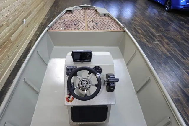 Slide: The Image of 2023 XTREME BOATS Brute 1754 CC interior with steering console and wooden flooring. - 14