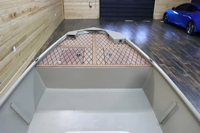 Slide: The Image of 2023 XTREME BOATS Brute 1754 CC in a wooden garage with a blue car. - 17