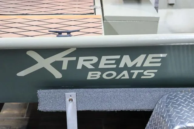 Slide: The Image of 2023 XTREME BOATS Brute 1754 CC, side view with logo and deck detail. - 7