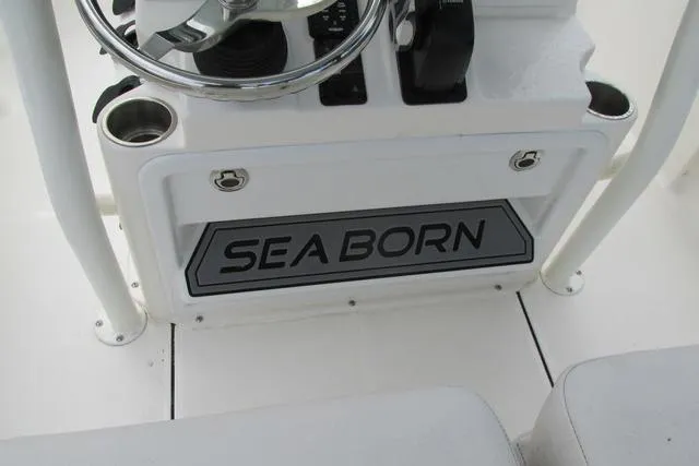 Slide: The Image of 2023 Sea Born FX22 boat console with steering wheel and cup holders. - 10