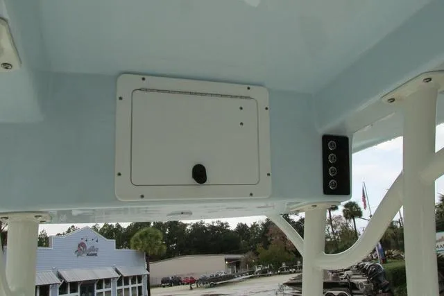 Slide: The Image of 2023 Sea Born FX22 boat console with storage compartment and control panel. - 11