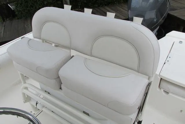 Slide: The Image of 2023 Sea Born FX22 boat with white cushioned seating and sleek design. - 12