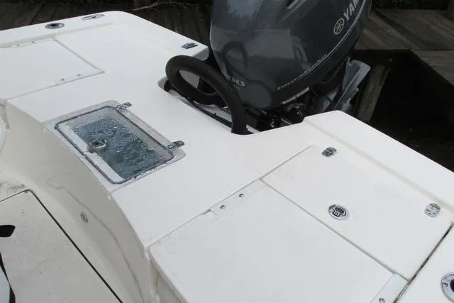 Slide: The Image of 2023 Sea Born FX22 boat with Yamaha engine, featuring a spacious deck layout. - 13