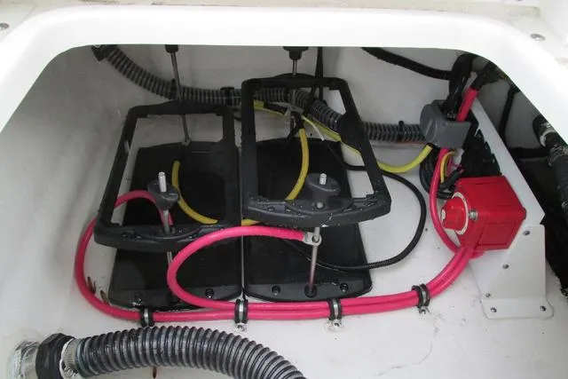 Slide: The Image of 2023 Sea Born FX22 boat battery compartment with wiring and connections. - 18