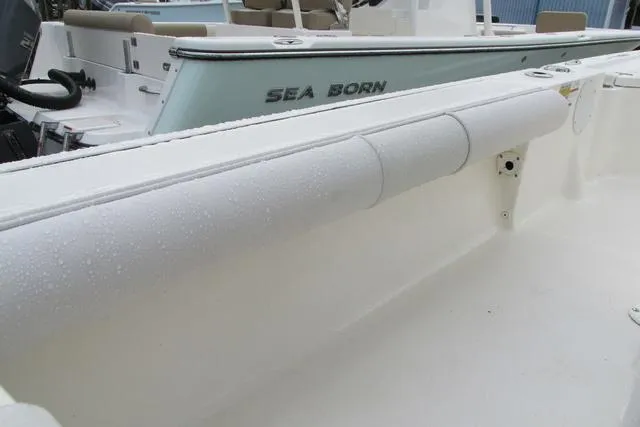 Slide: The Image of 2023 Sea Born FX22 boat with sleek white interior and visible branding. - 20