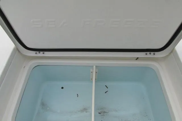 Slide: The Image of Open storage compartment in 2023 Sea Born FX22 boat, featuring a clean, spacious interior. - 23