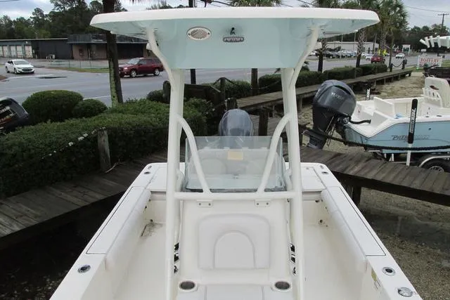 Slide: The Image of 2023 Sea Born FX22 boat with T-top, parked outdoors near a road. - 28