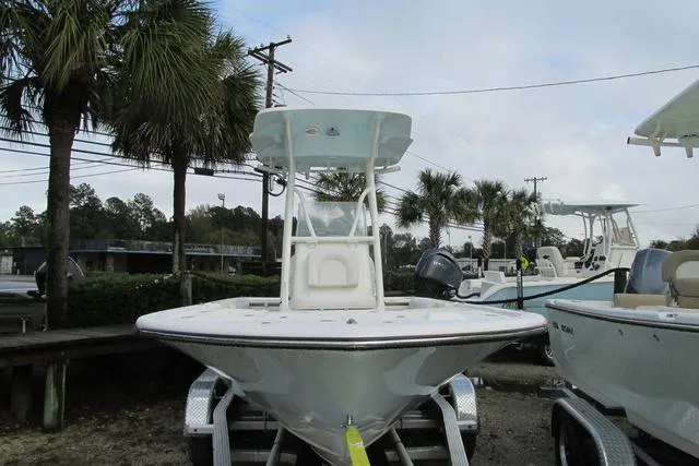 Slide: The Image of 2023 Sea Born FX22 boat on trailer, surrounded by palm trees and other boats. - 3