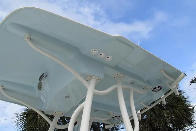 Slide: The Image of 2023 Sea Born FX22 boat canopy with speakers, viewed from below against a blue sky. - 5