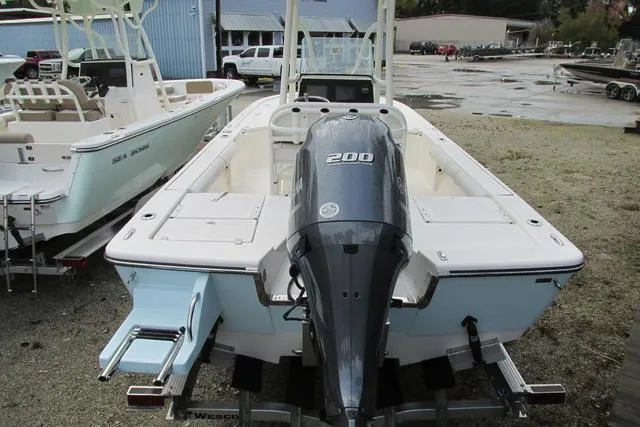 Slide: The Image of 2023 Sea Born FX22 boat with 200 HP engine, parked outdoors. - 7