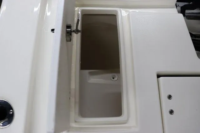 Slide: The Image of 2023 May-Craft 2200 Bay boat storage compartment with open lid, showcasing interior space. - 14