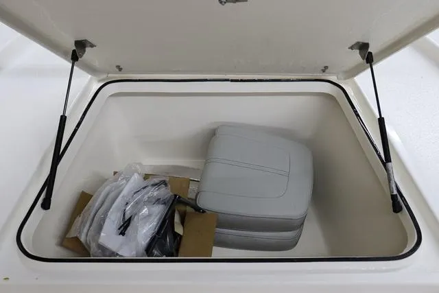 Slide: The Image of Open storage compartment in 2023 May-Craft 2200 Bay boat with seat cushion and accessories. - 19