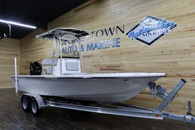 Slide: The Image of 2023 May-Craft 2200 Bay boat on trailer at dealership showroom. - 2