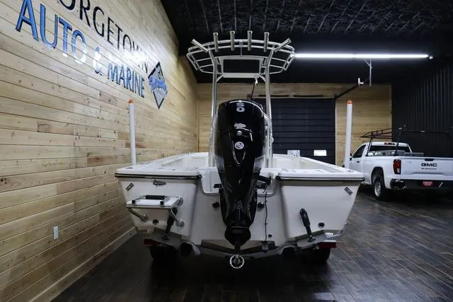 Slide: The Image of 2023 May-Craft 2200 Bay boat in showroom with wooden walls and GMC truck. - 4