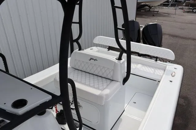 Slide: The Image of 2025 Yellowfin 26 Hybrid boat interior with white seating and black accents. - 10