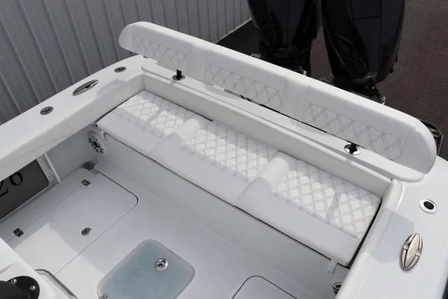 Slide: The Image of 2025 Yellowfin 26 Hybrid boat interior with white cushioned seating and sleek design. - 11