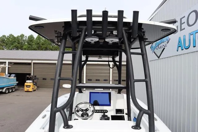 Slide: The Image of 2025 Yellowfin 26 Hybrid boat console with steering wheel and navigation screen. - 13