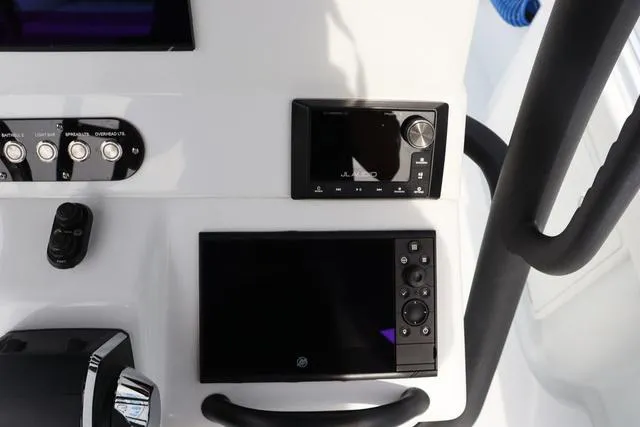 Slide: The Image of Control panel of 2025 Yellowfin 26 Hybrid boat with navigation and audio systems. - 21