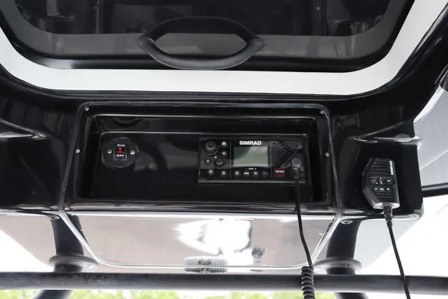 Slide: The Image of 2025 Yellowfin 26 Hybrid boat console with Simrad electronics and communication equipment. - 22