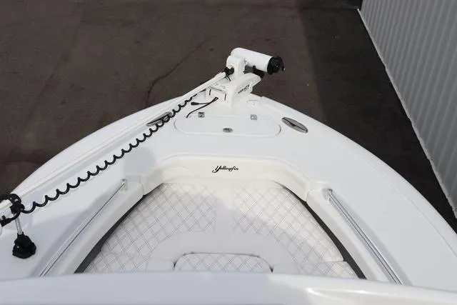 Slide: The Image of 2025 Yellowfin 26 Hybrid boat bow with trolling motor and cushioned seating. - 27