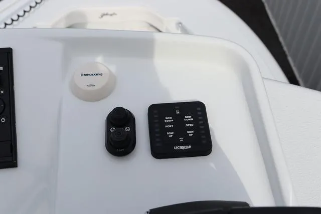Slide: The Image of Control panel of 2025 Yellowfin 26 Hybrid boat with SiriusXM and Lectrotab features. - 28