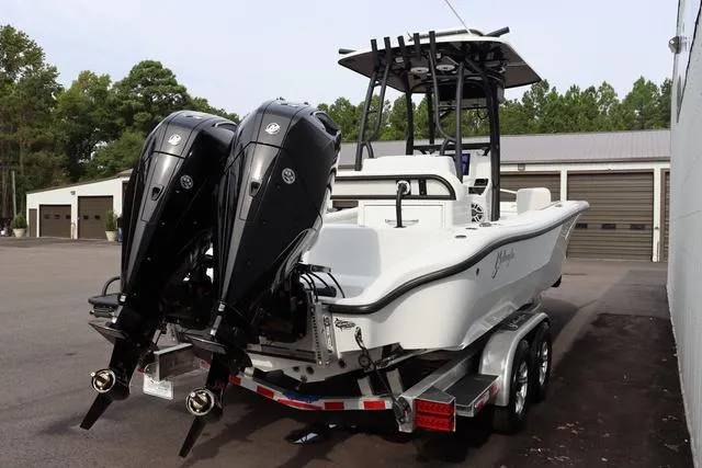 Slide: The Image of 2025 Yellowfin 26 Hybrid boat with dual outboard motors on a trailer. - 3