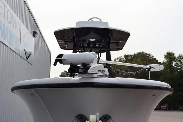 Slide: The Image of 2025 Yellowfin 26 Hybrid boat with advanced navigation equipment, docked near a marine facility. - 6