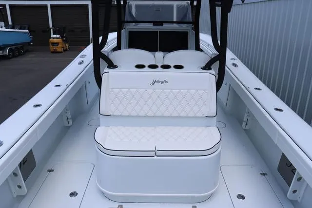 Slide: The Image of 2025 Yellowfin 32 boat interior with white seating and sleek design. - 11