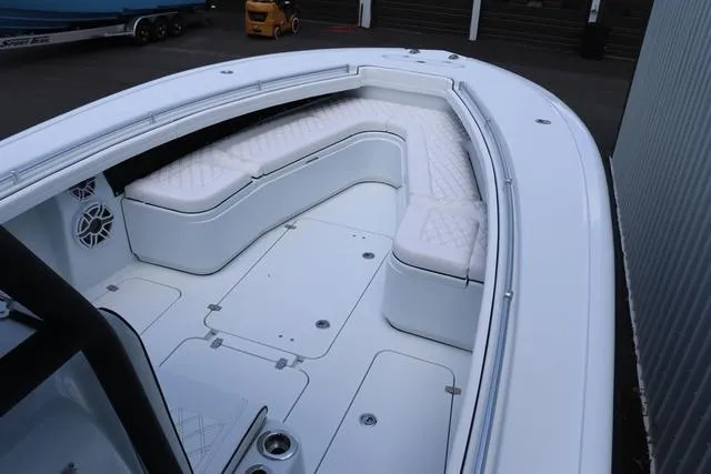 Slide: The Image of 2025 Yellowfin 32 boat with white cushioned seating and spacious deck. - 12