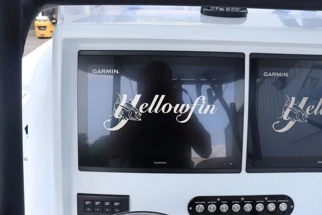 Slide: The Image of 2025 Yellowfin 32 boat dashboard with dual Garmin displays. - 13