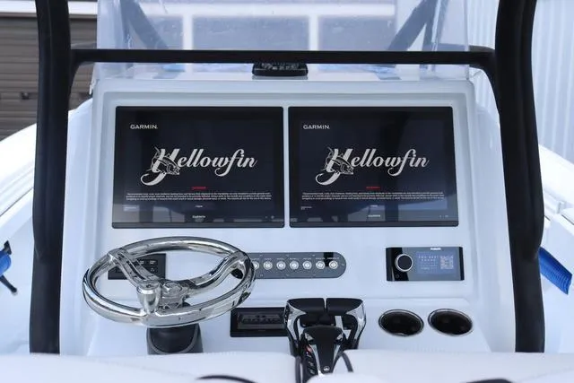 Slide: The Image of 2025 Yellowfin 32 boat dashboard with dual Garmin displays and steering wheel. - 14