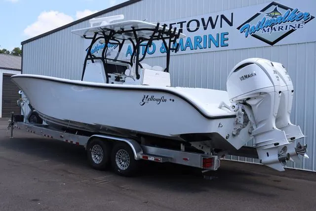 Slide: The Image of 2025 Yellowfin 32 boat on trailer at dealership, featuring dual Yamaha engines. - 3