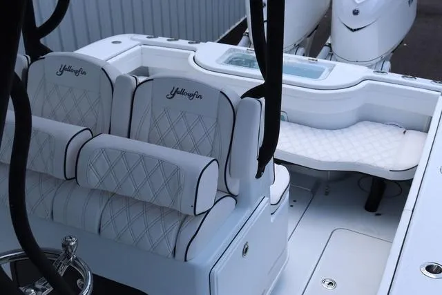 Slide: The Image of 2025 Yellowfin 32 boat interior with white cushioned seating and elegant design. - 9