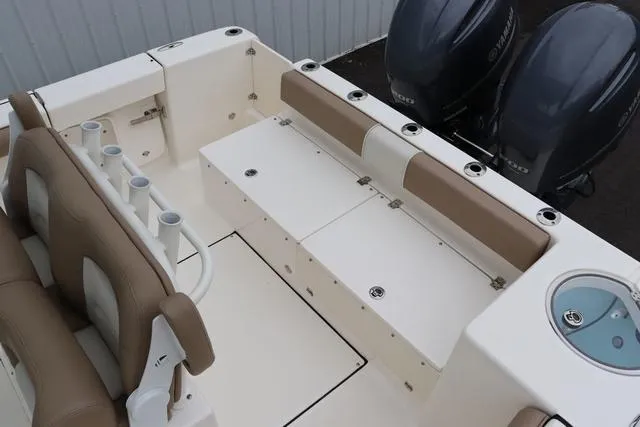 Slide: The Image of 2023 Sea Born LX26 boat interior with seating, rod holders, and dual engines. - 10