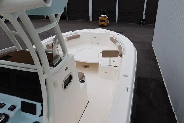 Slide: The Image of 2023 Sea Born LX26 boat with spacious deck and modern helm, docked in a marina. - 13