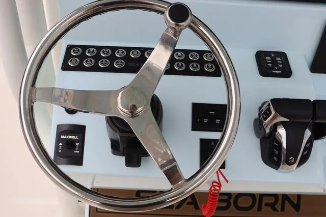 Slide: The Image of 2023 Sea Born LX26 helm with steering wheel and control panel. - 14