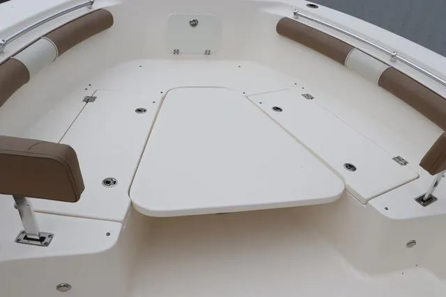 Slide: The Image of 2023 Sea Born LX26 boat interior with cushioned seating and storage compartments. - 17