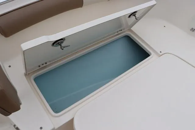 Slide: The Image of 2023 Sea Born LX26 boat storage compartment with open lid, showcasing interior space. - 18