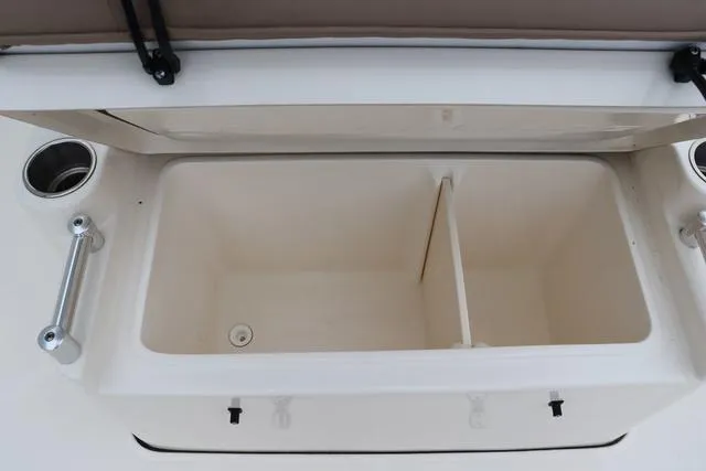 Slide: The Image of 2023 Sea Born LX26 boat storage compartment with open lid and cup holders. - 21